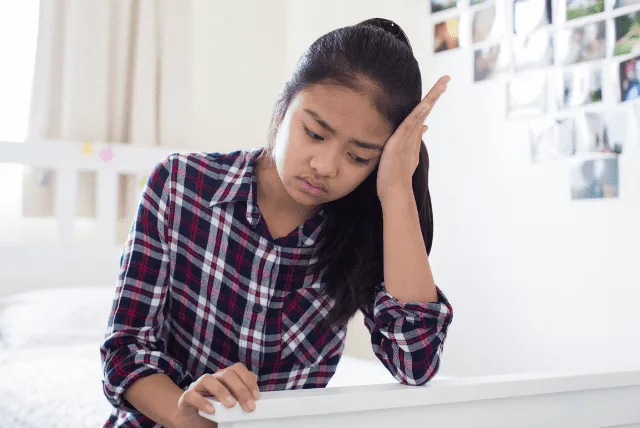 adopted girl sitting on bed