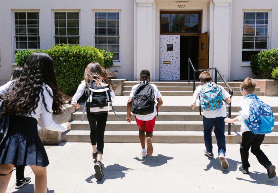 Kids running back to school building