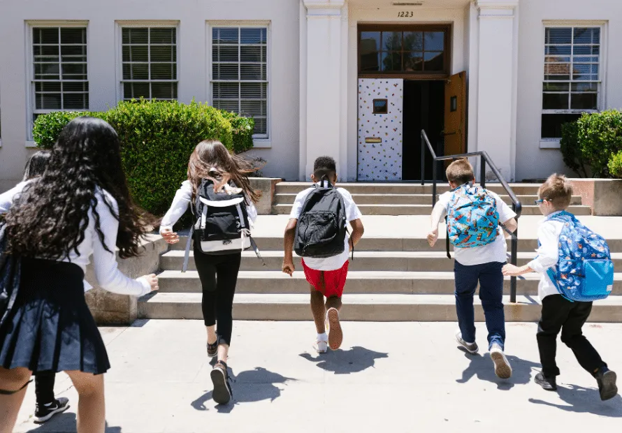 Kids running back to school building