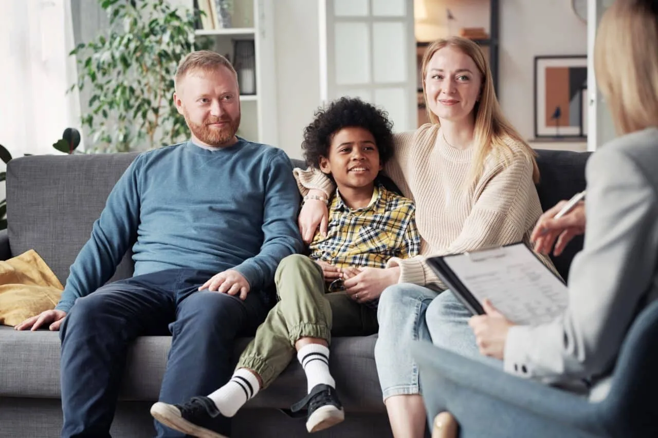 Interracial family speaking to a therapist