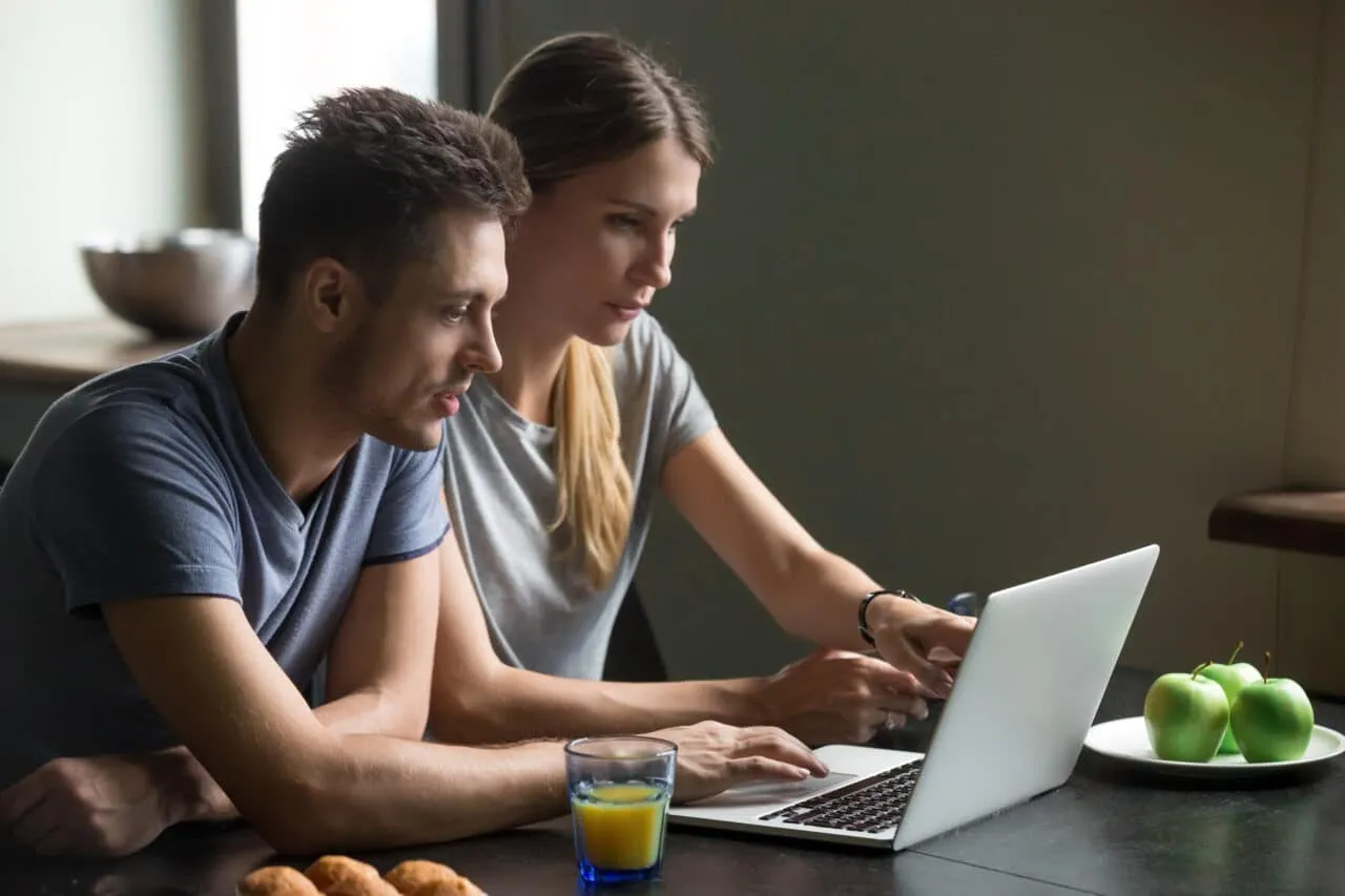 Couple using laptop for webinar
