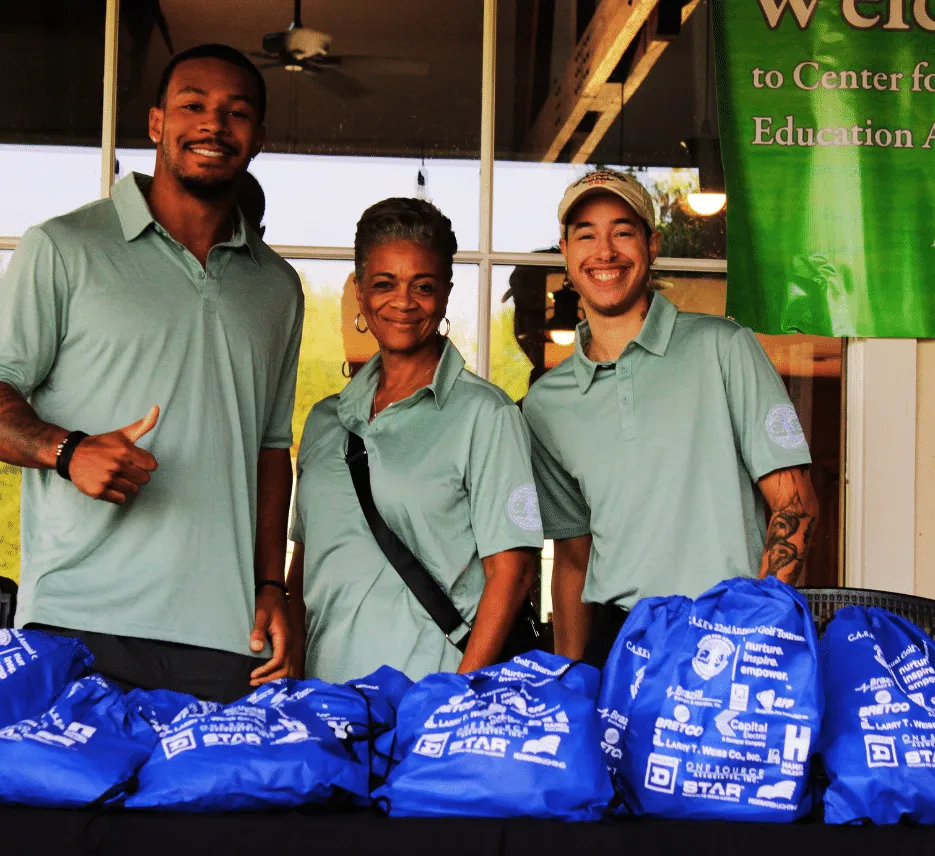 CASE staff members smiling together at golf tournament fundraising event