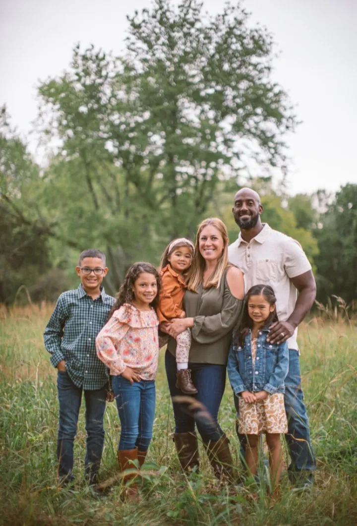 Racially diverse adoptive family posing for photo