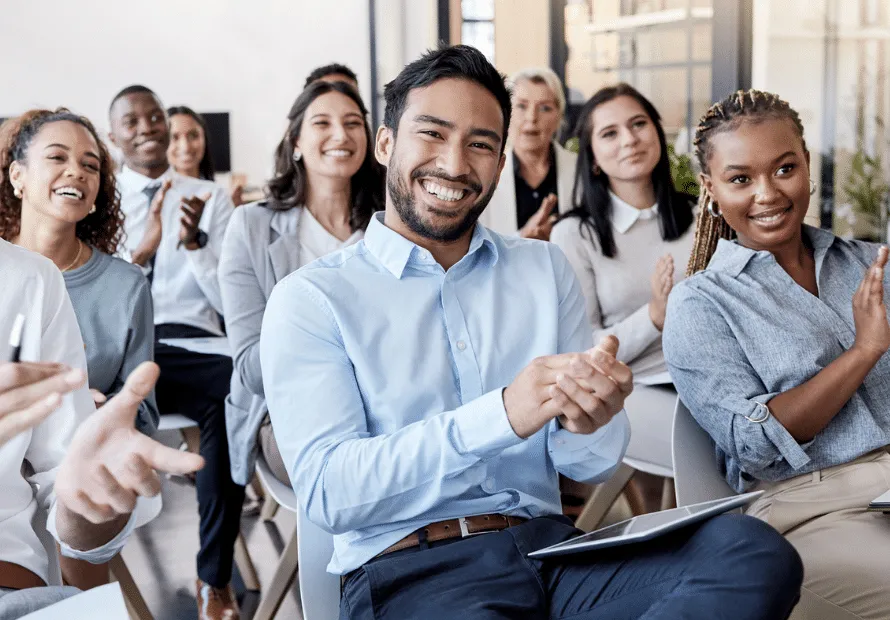 Young professionals smiling to camera and clapping