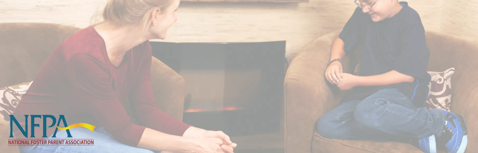 Woman sitting on chair talking to teenage boy sitting on chair