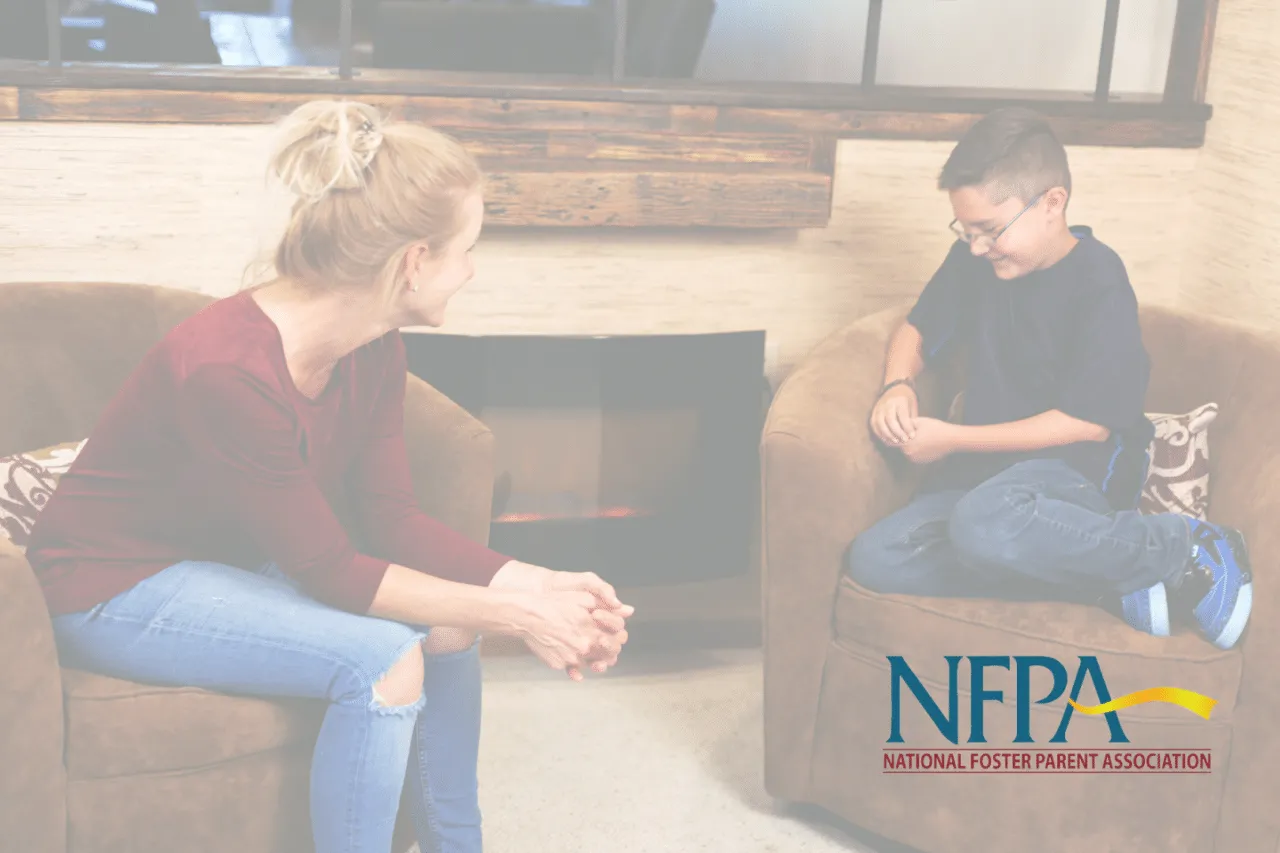 Woman sitting on chair talking to teenage boy sitting on chair
