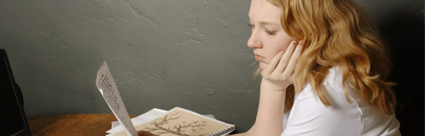 Teen girl looking at a genealogy paper