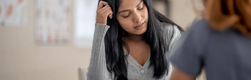 Teenage girl with eyes closed looking confused