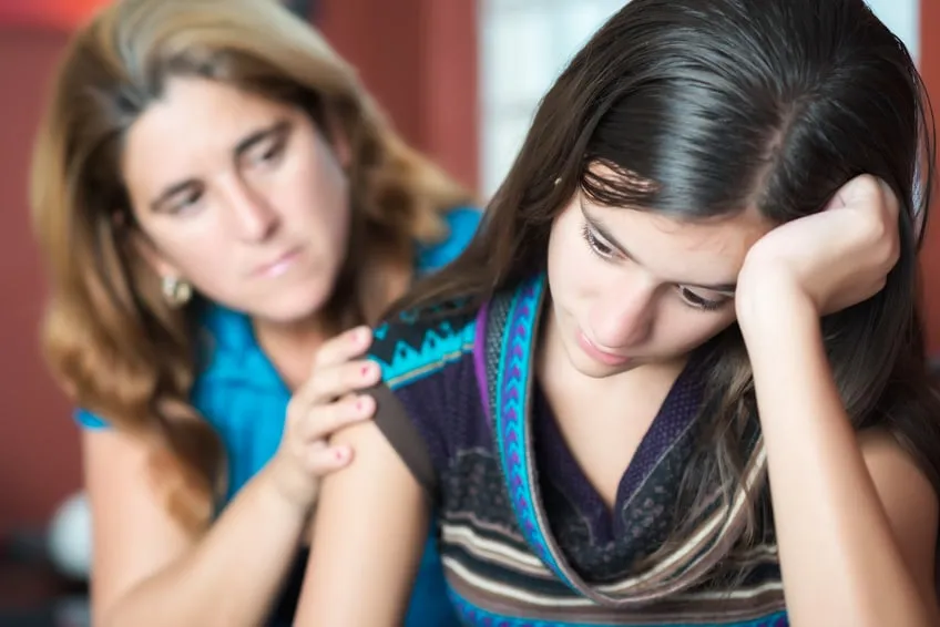 Teenager problems - Mother comforts her troubled teenage daughter