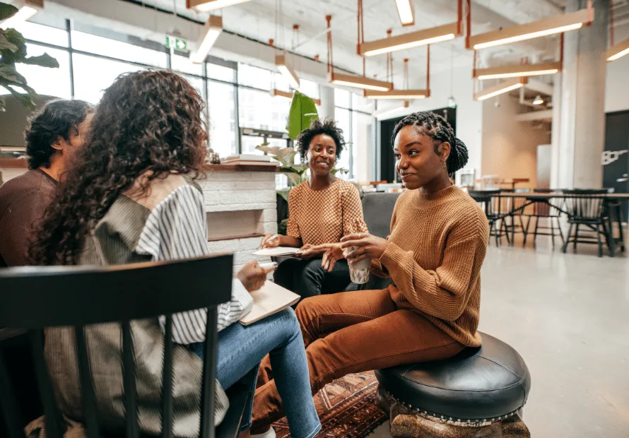 Diverse group of young adults sitting in circle talking