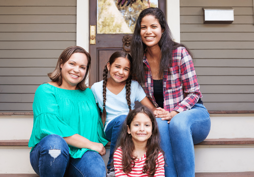 Hispanic women smiling with two girl children