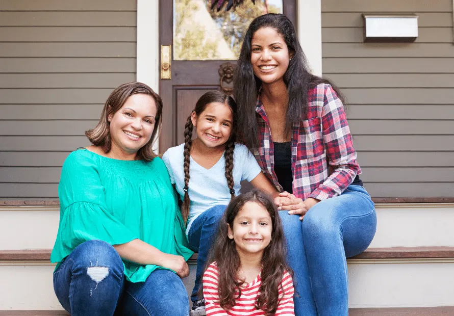 Hispanic women smiling with two girl children