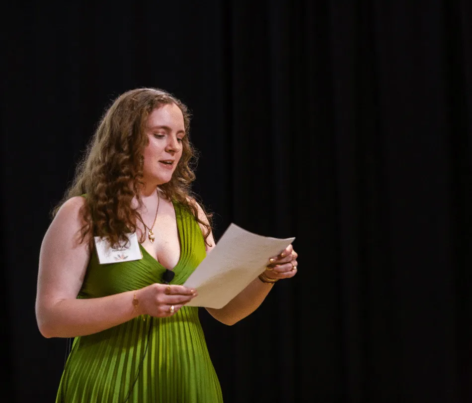 Emily Kwiatkowski, Adult Adoptee and Emerging Leader speaking on stage at Annual Gala
