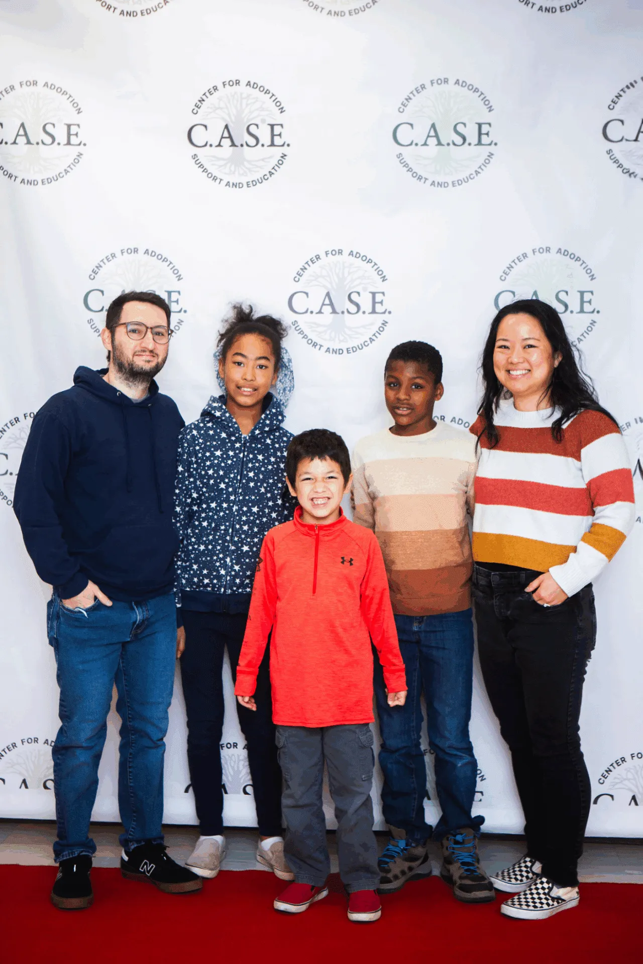 Adoptive family posing and smiling together