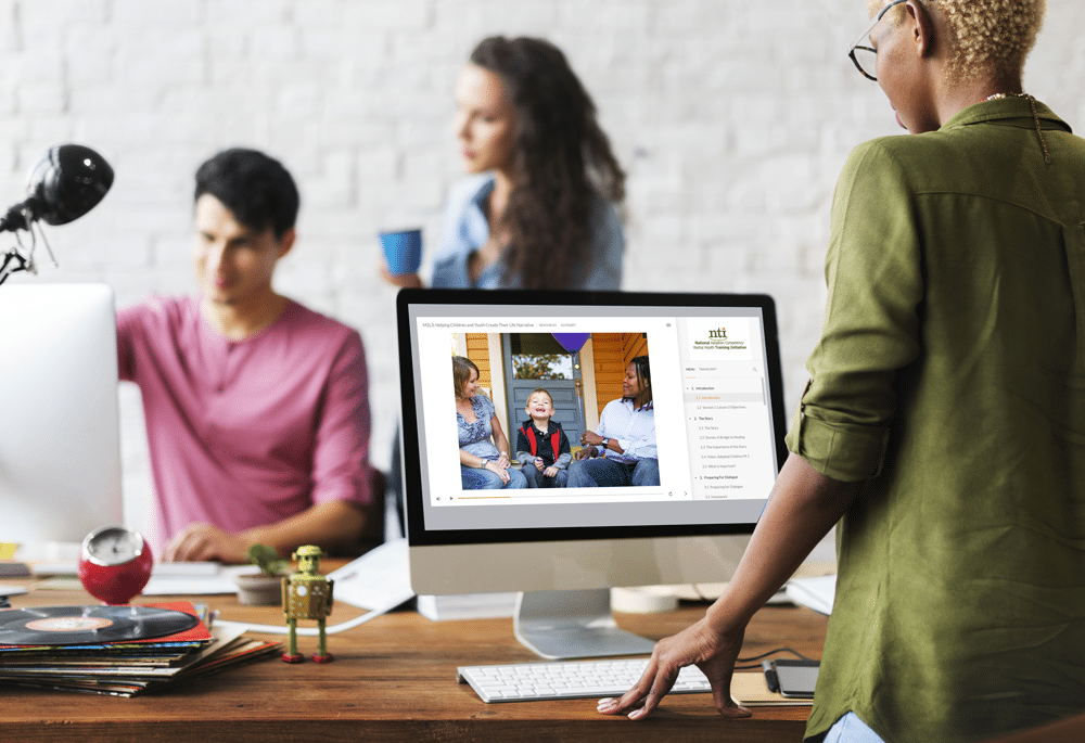 Professionals looking at online training on a computer