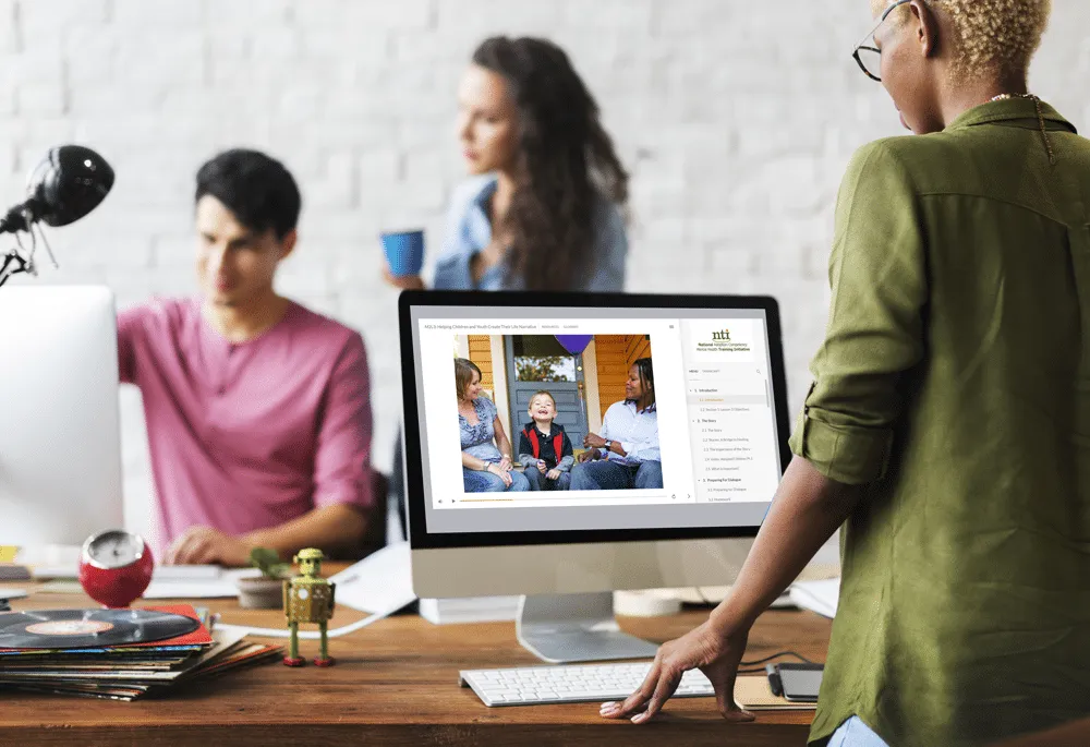 Professionals looking at online training on a computer