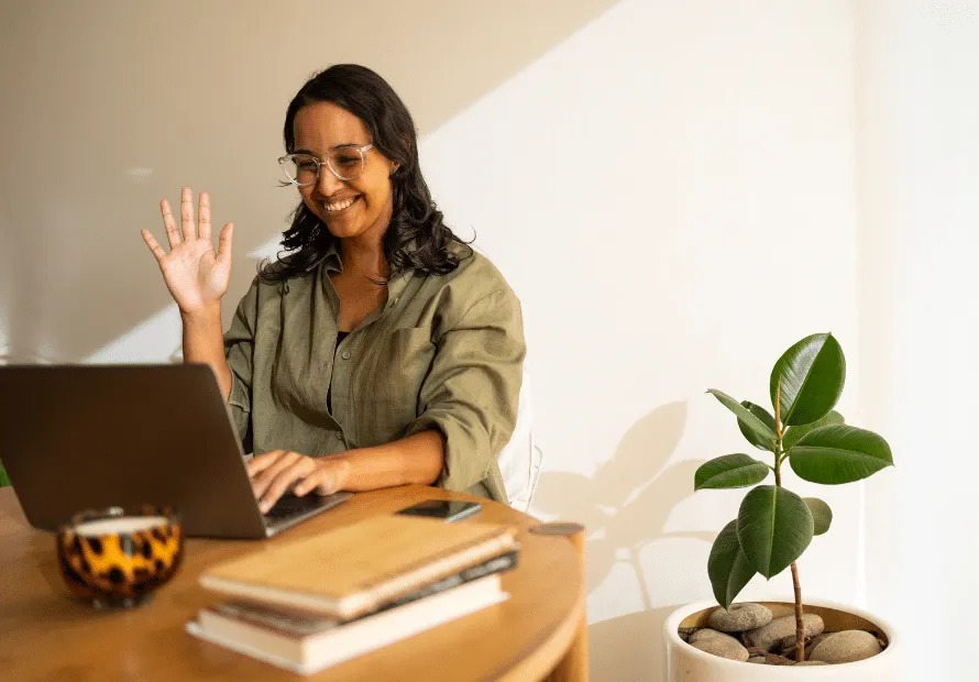 Adoptive parent waving at other adoptive parents on laptop