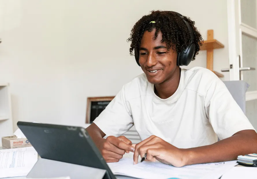 Teen boy speaking to others teens on laptop about the holidays
