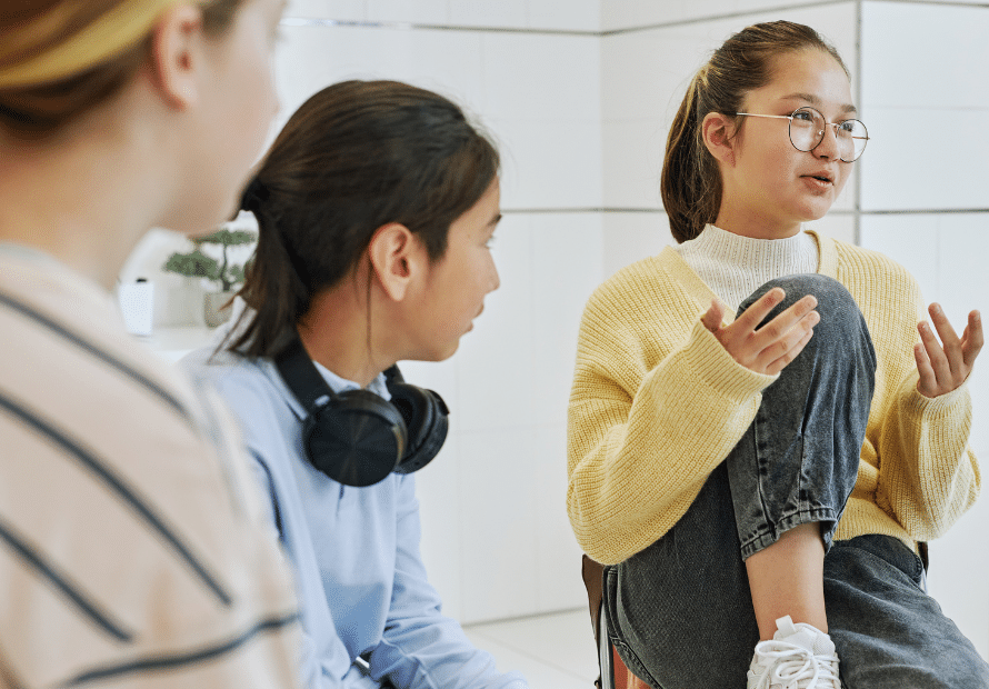Tween girl talking with other teens in support group