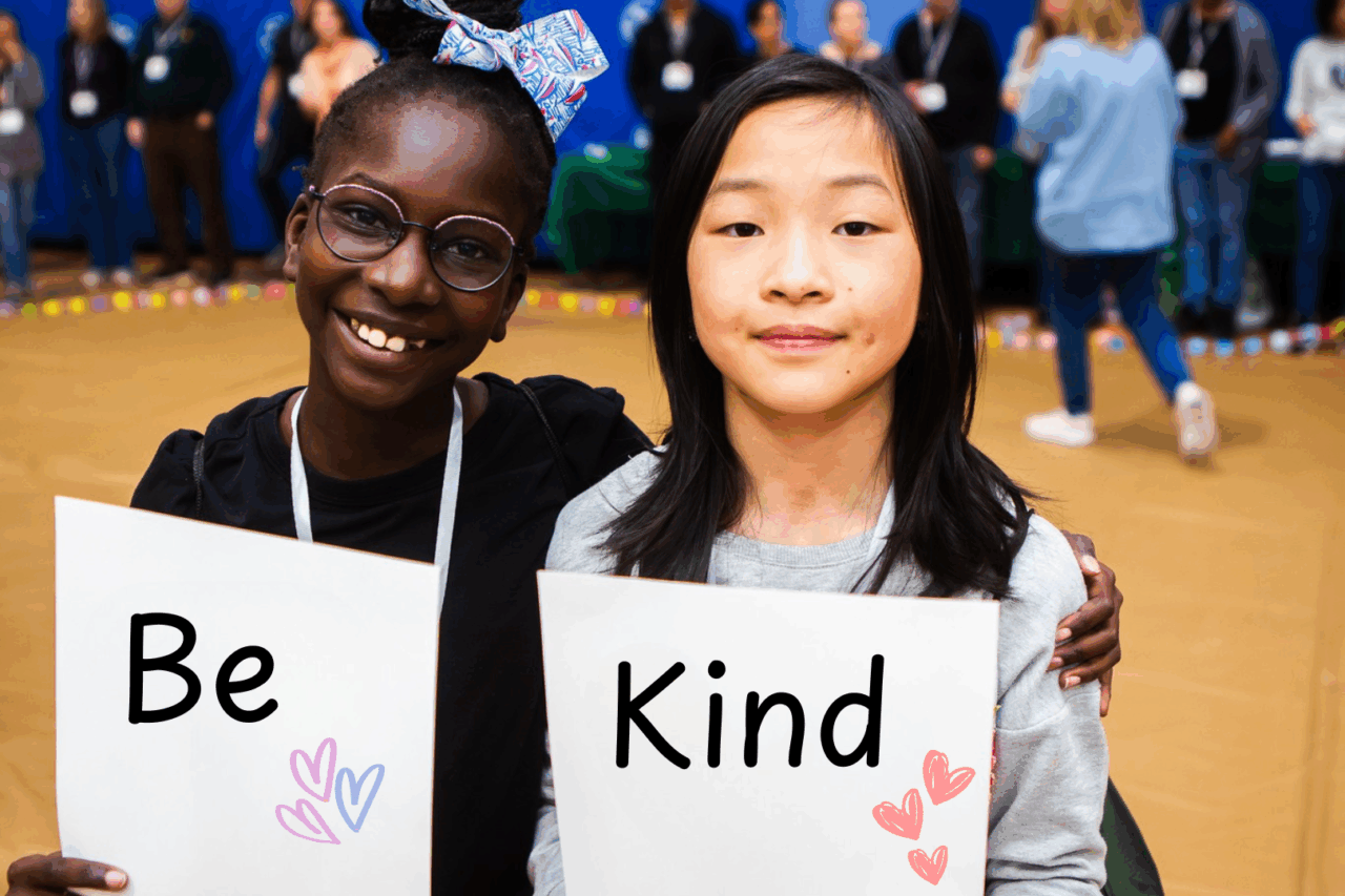 Young black girl holding sign 