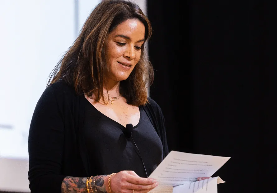 Rachel Shifaraw reading to crowd about adoption journey