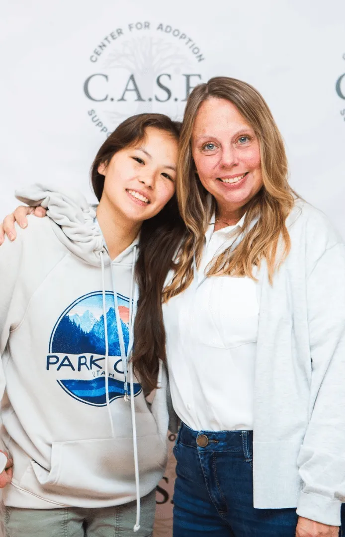 Adoptive Mom and Adoptive Daughter standing posing smiling together